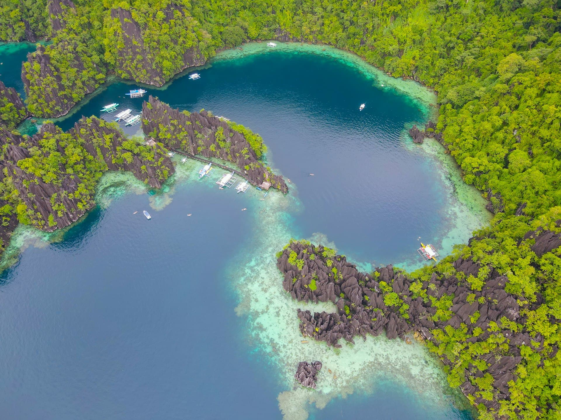 Aerial view of the forested limestone islands and blue lagoons of Coron, Palawan