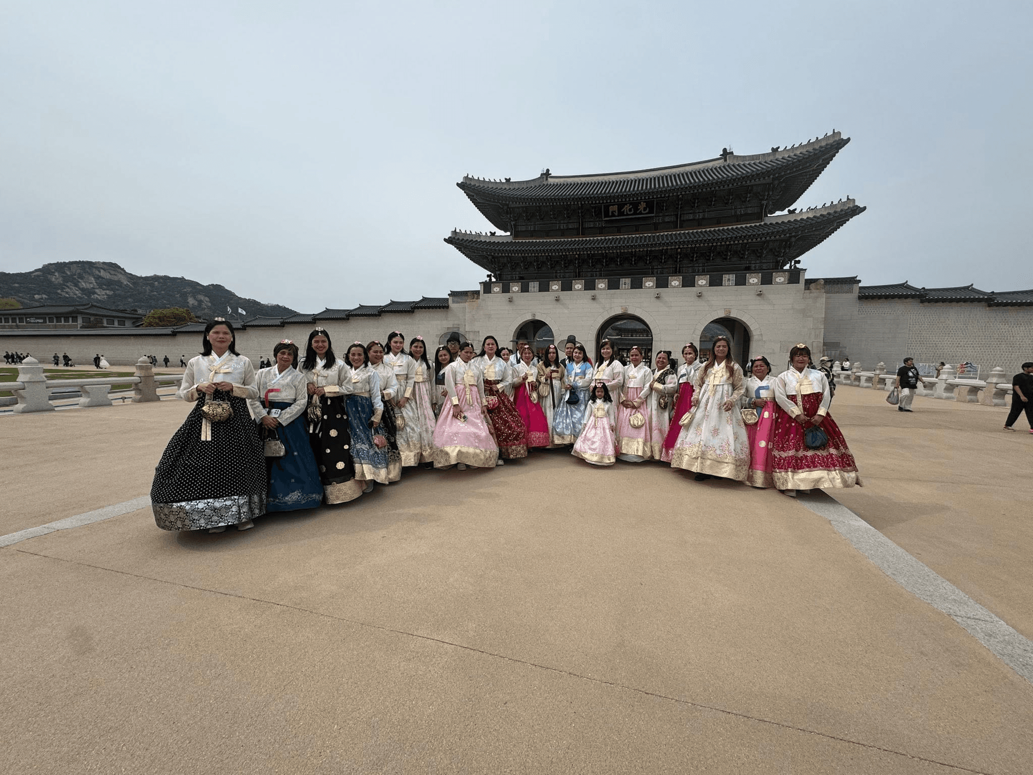 World Master International Travel tour group in hanbok at Gwanghwamun Gate, Gyeongbokgung Palace, Seoul